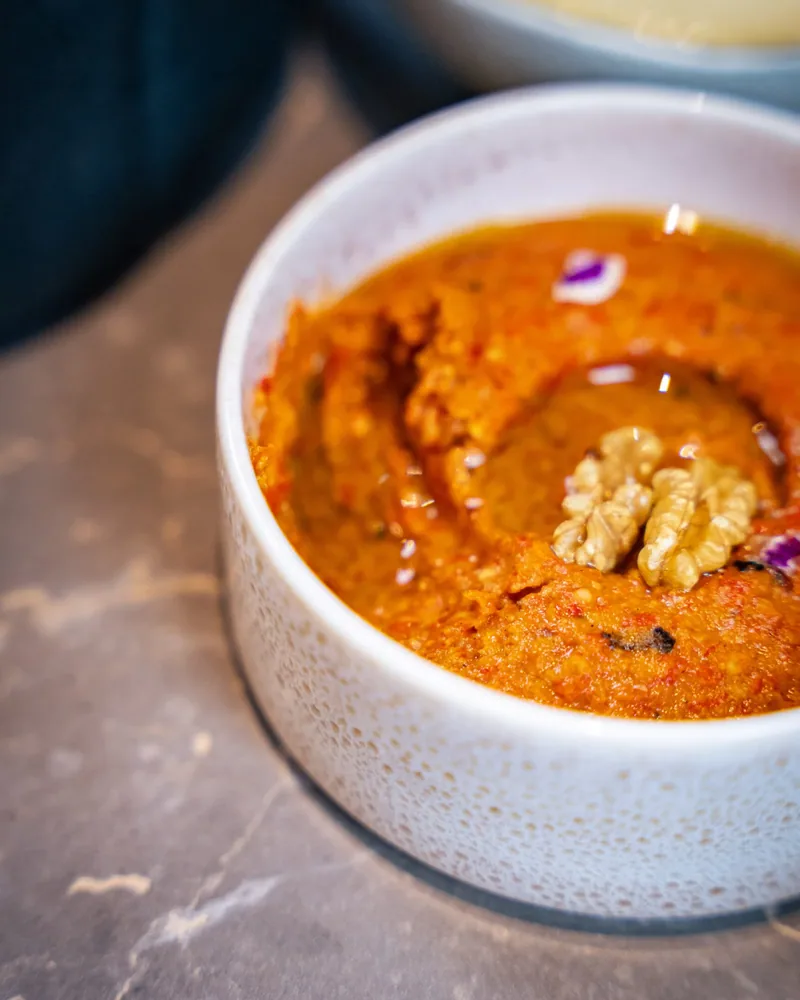 Muhammara, close, with a walnut on top